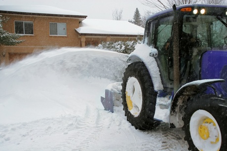 Snow plow removing snow